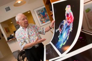 Irving Olson holding his painting